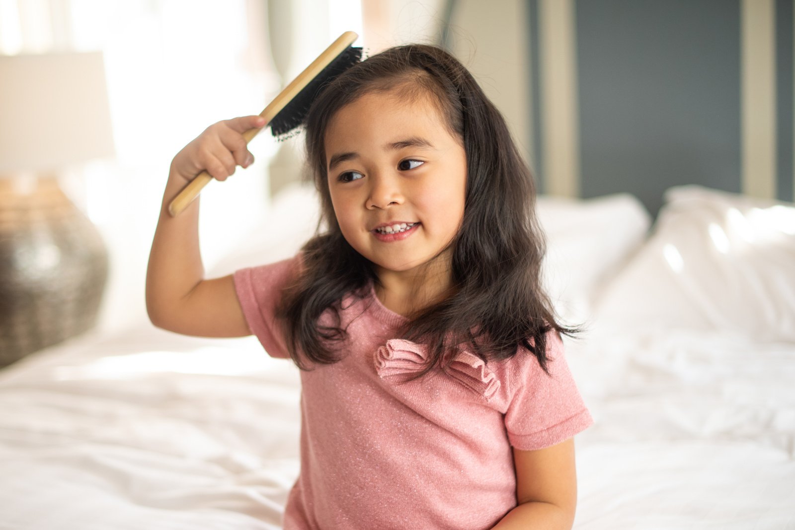 Smiling Little Girl Brushing Her Hair